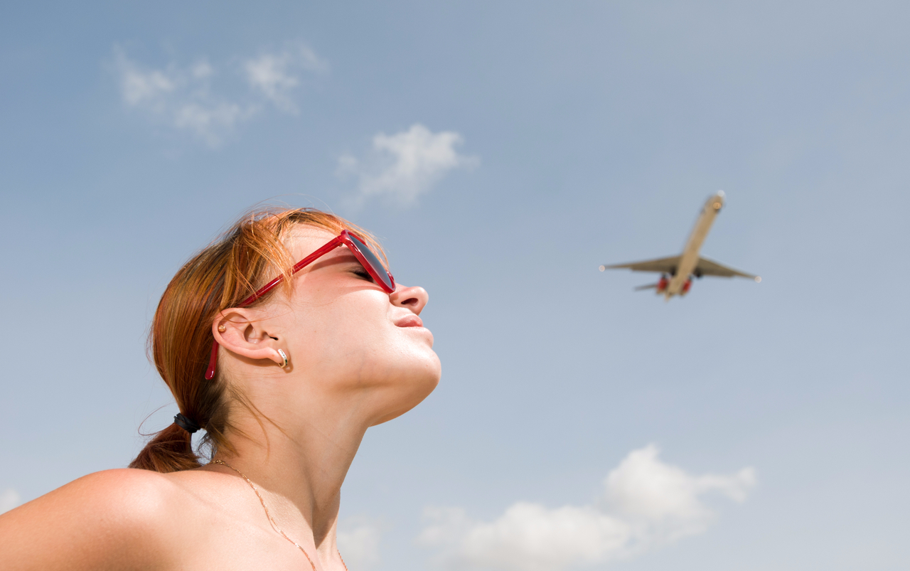 Woman watching a plane depart