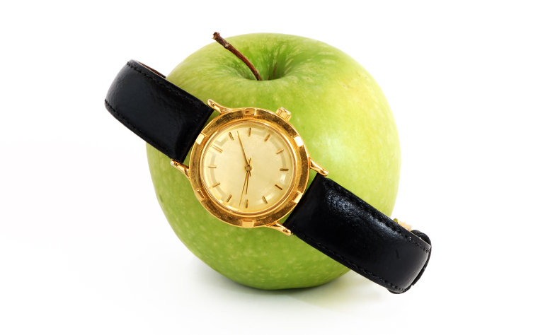A watch on an apple, as a play on the words "Apple Watch"