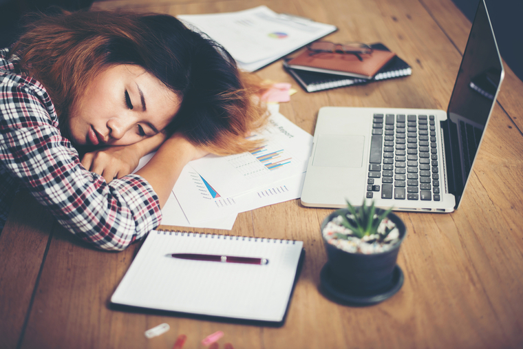 Woman taking a quick, 10-minute nap at her desk